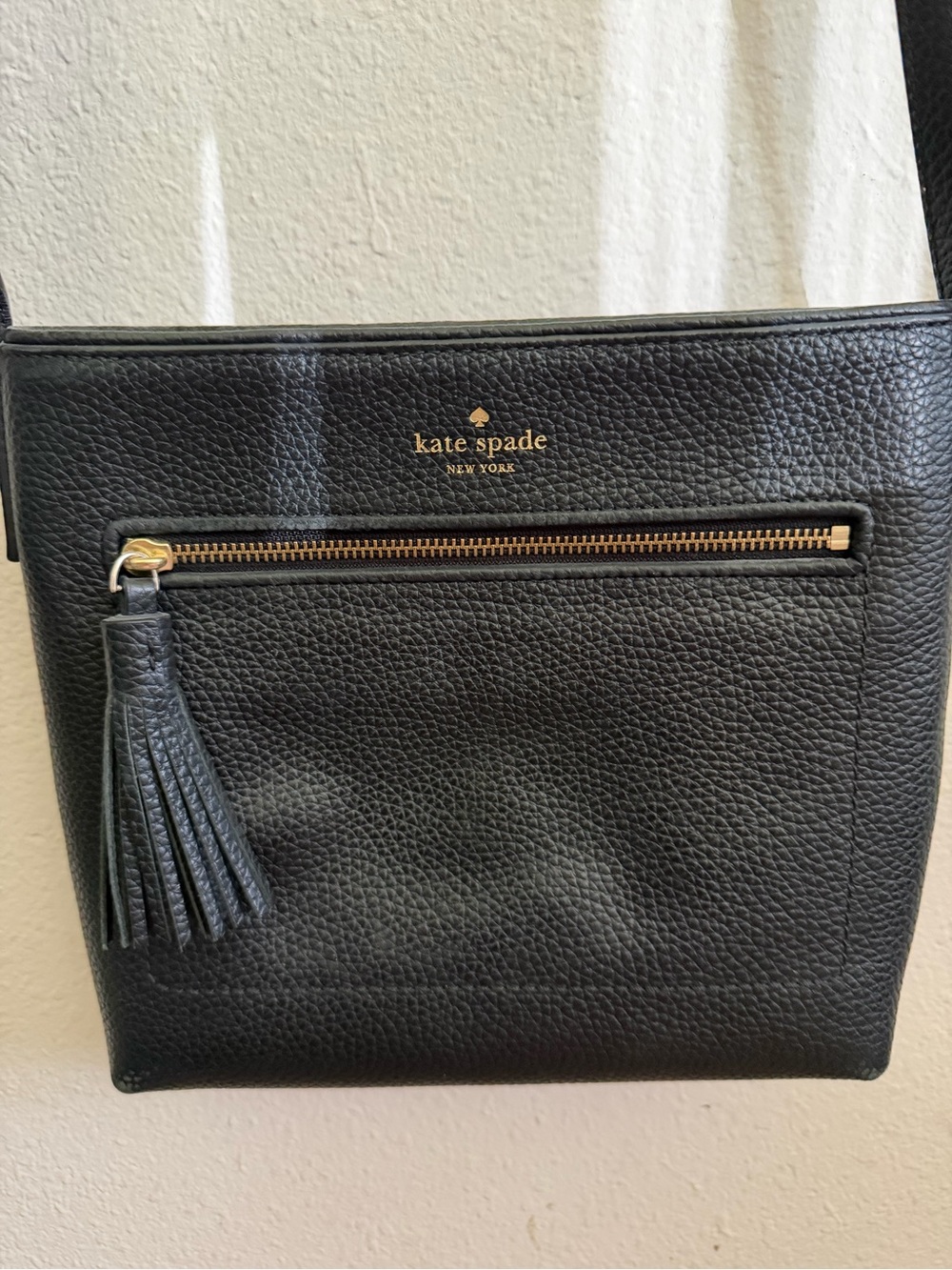 kate spade black pebbled leather crossbody with tassel and gold-tone trim